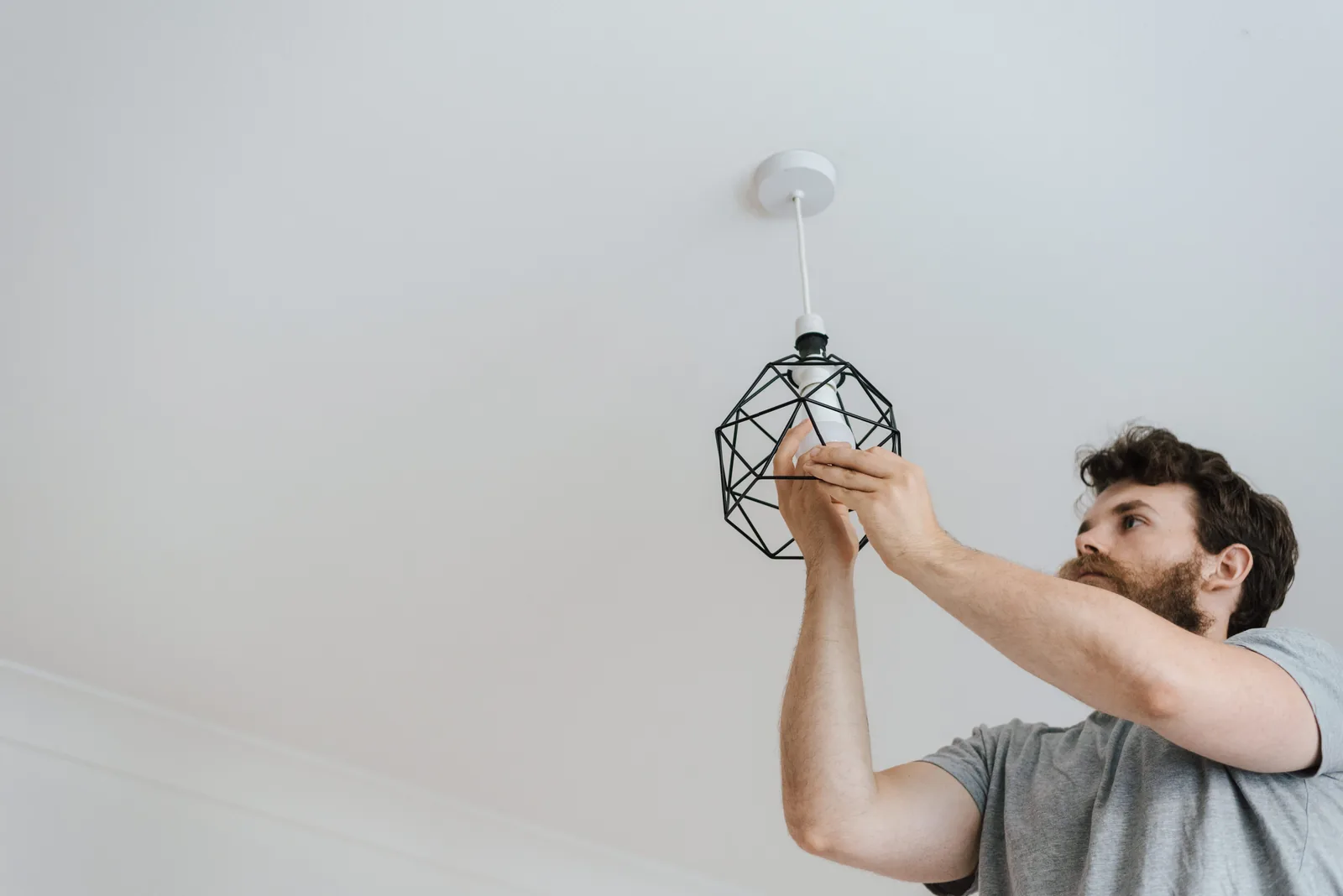 Fitting a lamp into a pendant fixture, for ev charger installation in Surrey